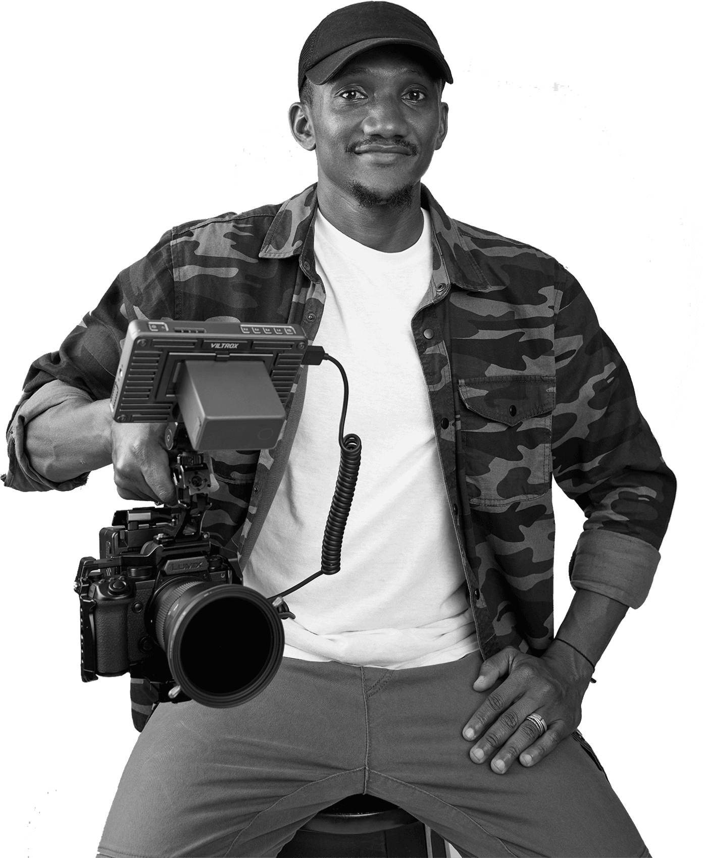 Sulemana seated with a cinema camera rig, black and white portrait